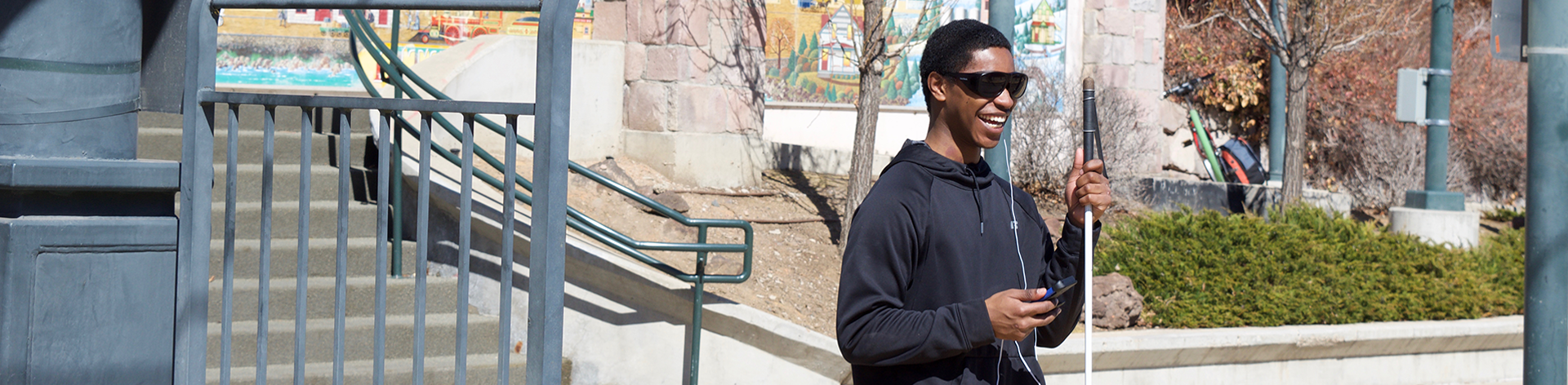 Blind man listening to NFB Newsline® while walking.